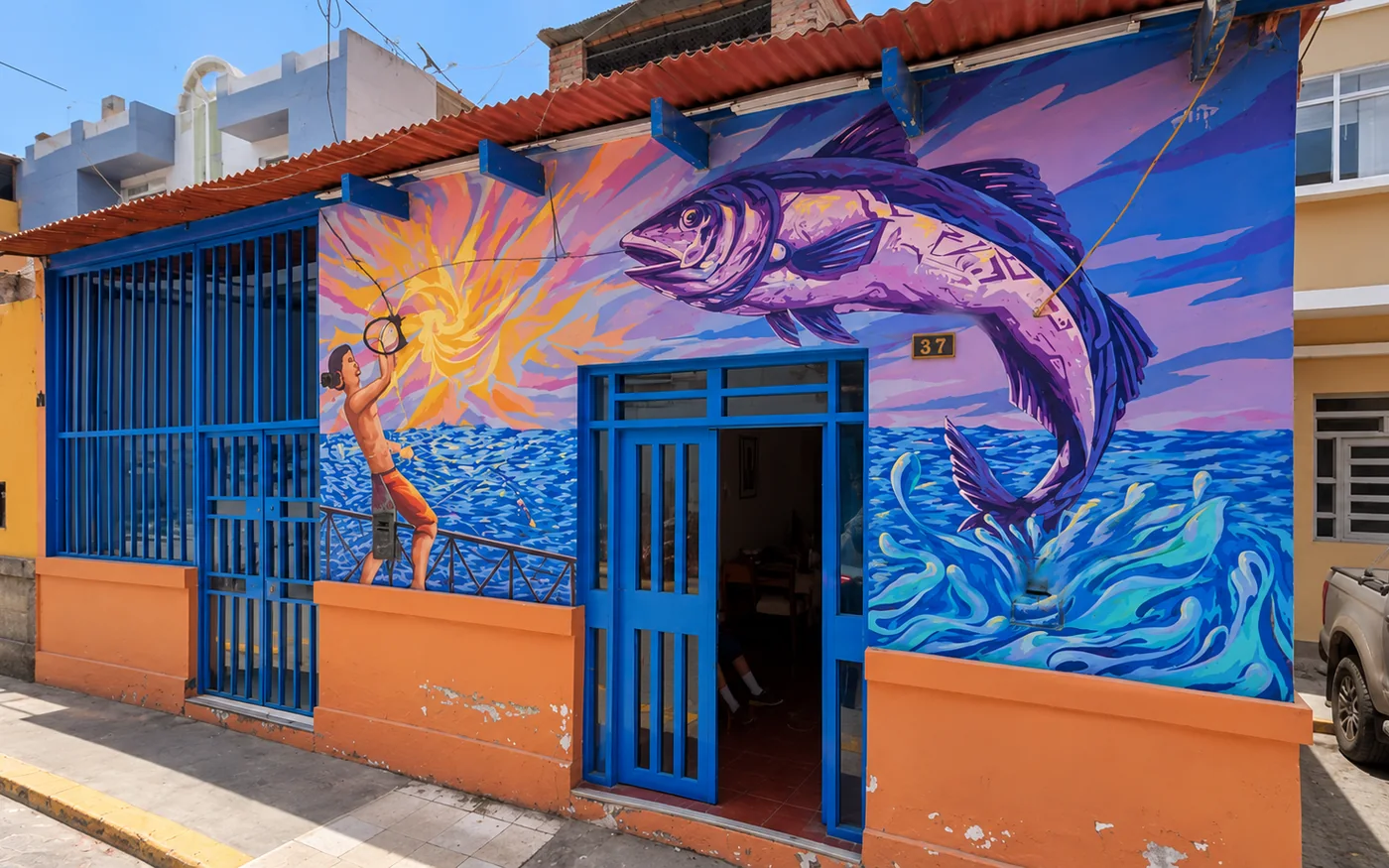 The façade of the new building, with the fish mural over the blue wall and the door open