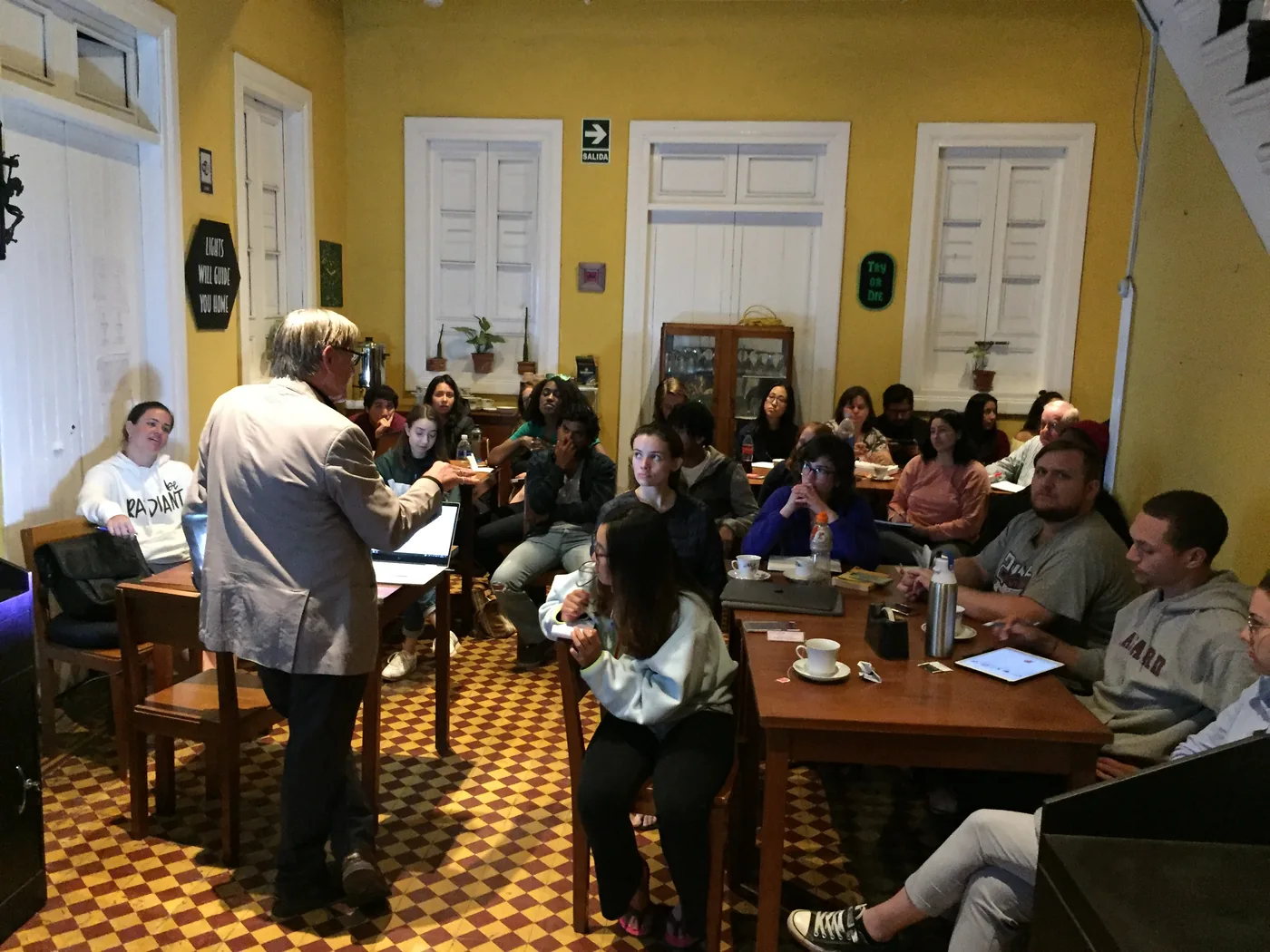 A talk for the group in the dining room, with the tables put together and everyone seated