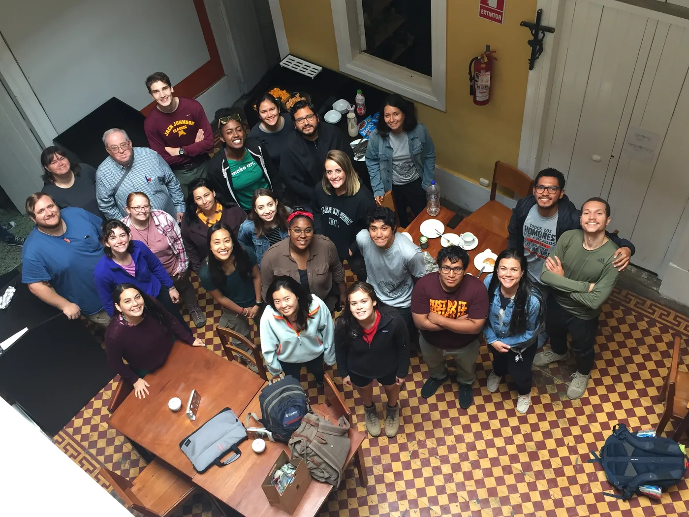 The whole group posing in the dining room of the old house, seen from the mezzanine
