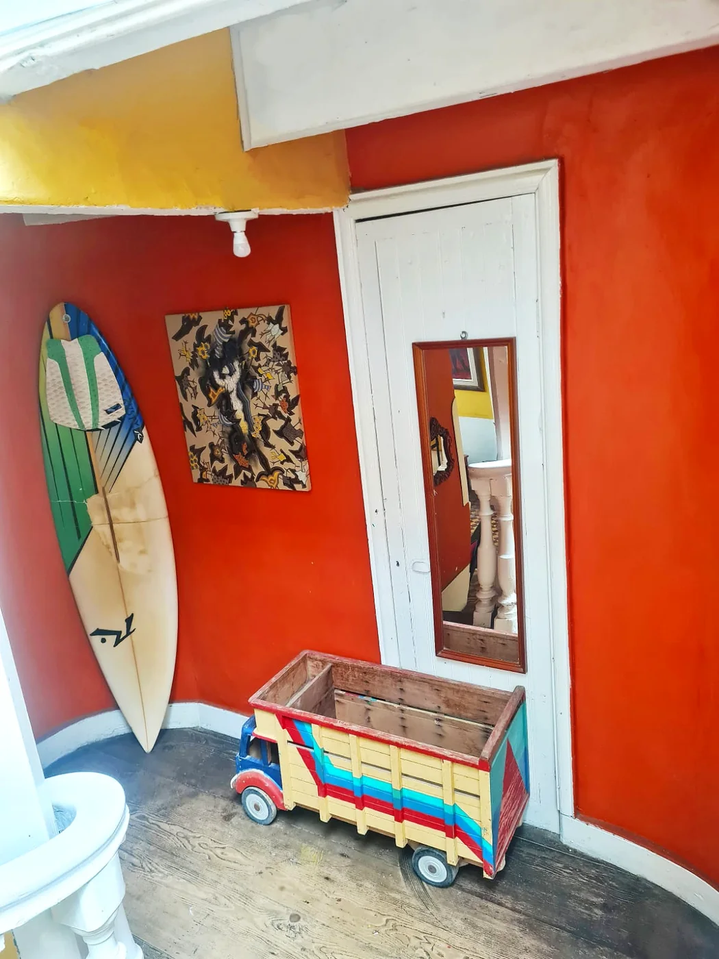 Room in the old house with a surfboard leaning against the wall