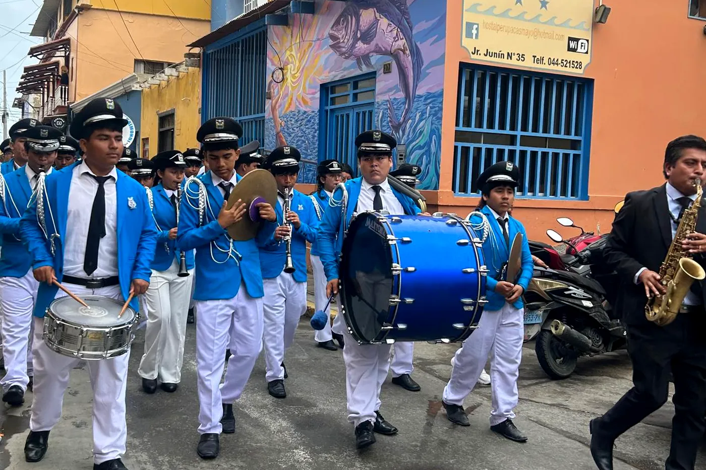 A school band playing in a street in the centre of Pacasmayo, in front of coloured façades