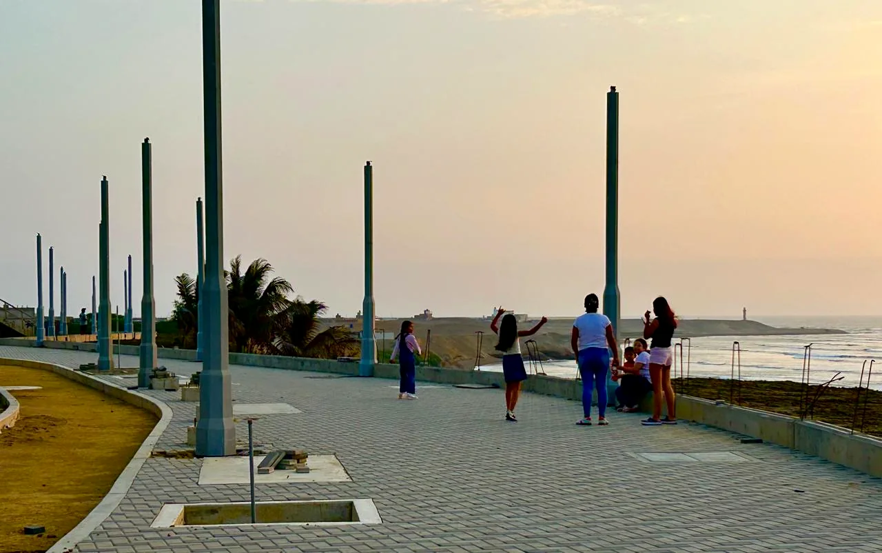People walking along the new seafront late in the afternoon