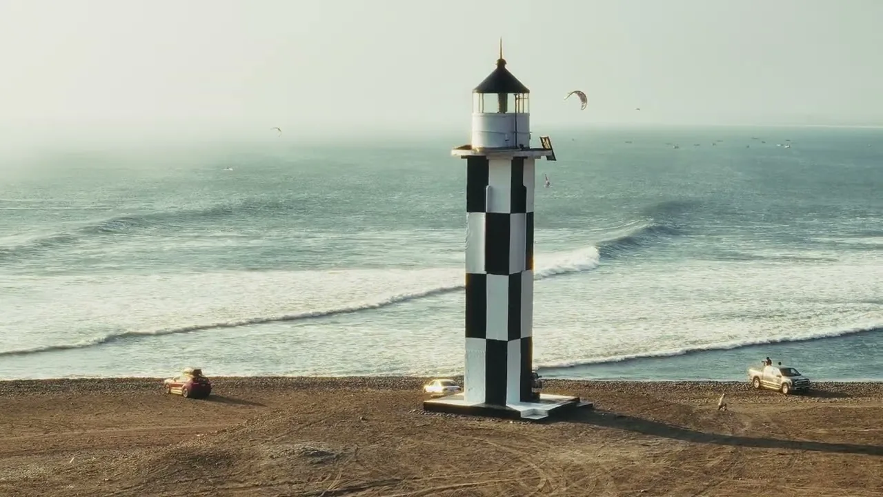 Kite and board over the wave, with the point of Pacasmayo behind