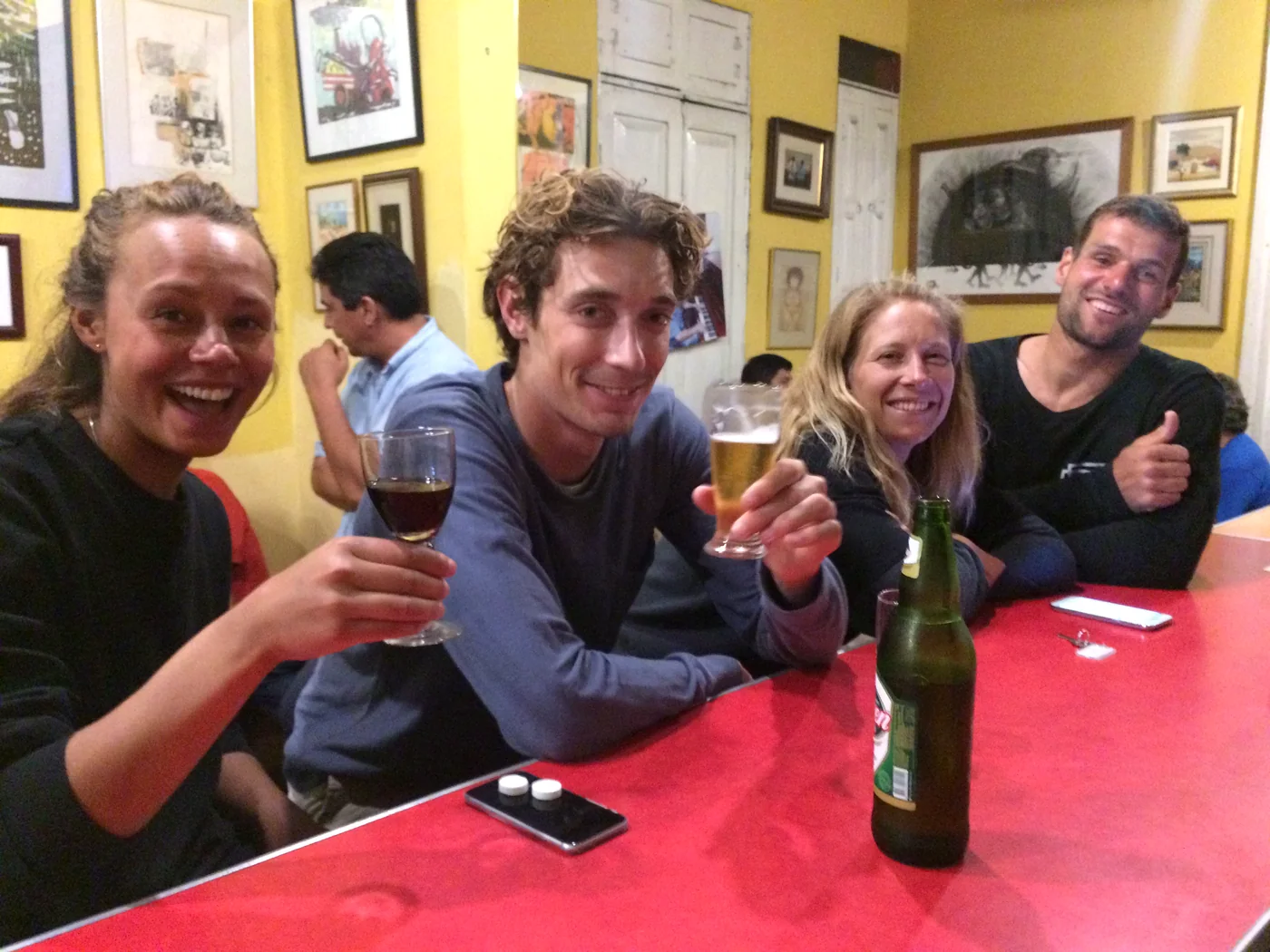 Guests raising a toast at the long table of the café-bar